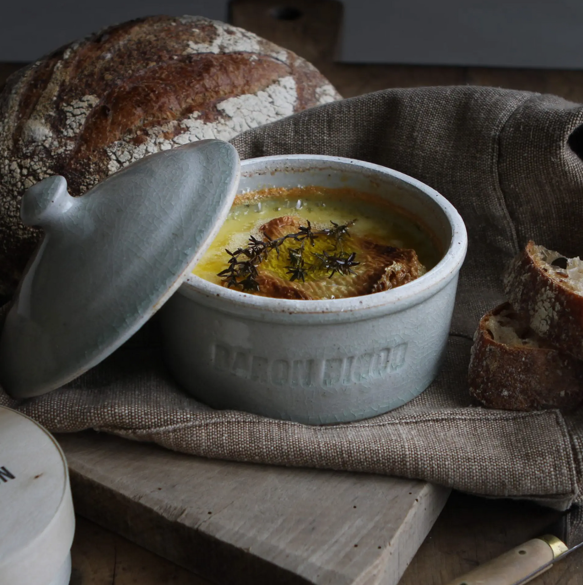 Hand-thrown by local Suffolk potter (and Dulcie’s dad), Mark Titchiner in his hand-built kiln. Our beautiful brie bakers have been created especially for us and come individually stamped with our Baron Bigod logo. They are made from soda-glazed stoneware which reacts with the heat of the kiln to create a beautiful patina, meaning each one is completely unique.