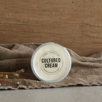 Fen Farm Dairy cultured cream pot on rustic cloth with wooden background